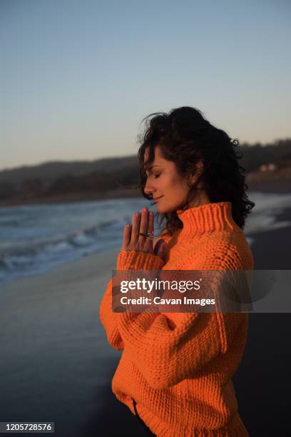 peaceful woman takes in the view at sunset - audit stock pictures, royalty-free photos & images