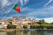 View on the old university city of Coimbra and the medieval capital of Portugal with Portuguese flag. Europe
