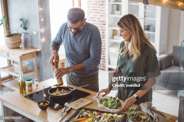 ロマンチックな野菜ディナー - middle aged couple cooking ストックフォトと画像