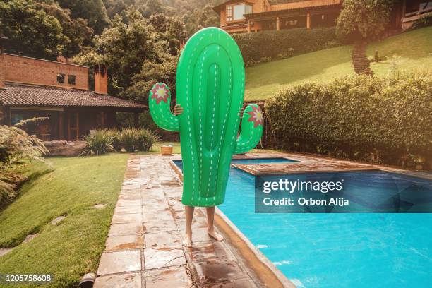 man with inflatable cactus in mexico - man on float stock pictures, royalty-free photos & images