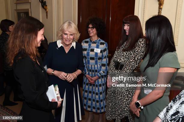 Camilla, Duchess of Cornwall talks to CEO of SafeLives Suzanne Jacob , SafeLives staffers Michelle Phillips, Melani Morgan and Susie Hay during a...