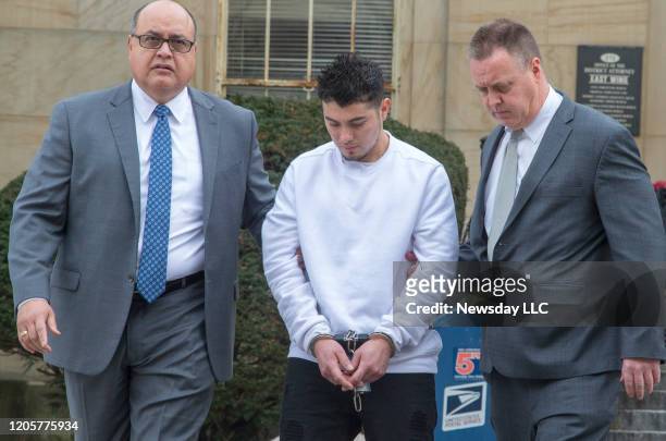 Gang leader Victor Lopez is led out of the Nassau County District Attorney's office in Mineola, New York on January 11, 2018. Lopez is one of two of...