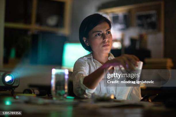 fbi detective using projector in the office - female fbi stock pictures, royalty-free photos & images