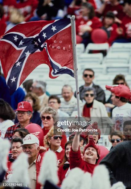 Fans of the University of Arkansas Razorbacks fly the Confederate Stars and Bars flag during the NCAA Southwest Conference college football game on...