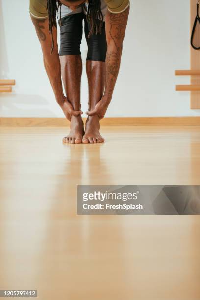 a sportsman doing body stretching exercise - pilates abstract stock pictures, royalty-free photos & images