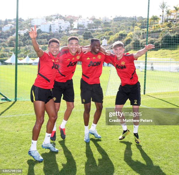 Jesse Lingard, Mason Greenwood, Aaron Wan-Bissaka and Brandon Williams of Manchester United in action during a first team training session on...