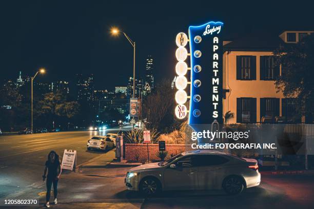 vibrant rainy street historic district in austin-texas at night - austin nightlife stock pictures, royalty-free photos & images