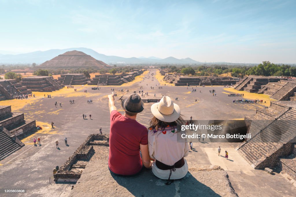 Tourists couple admiring the view of Teotihuacan archaeological site, Mexico