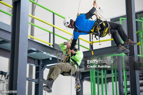 giving a helping hand - rope high rescue stock pictures, royalty-free photos & images