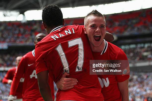 Tom Cleverley of Manchester United celebrates with goalscorer Nani after he scores the winning goal during the FA Community Shield match sponsored by...