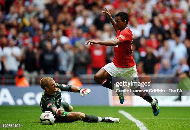 Nani of Manchester United skips past goalkeeper Joe Hart of Manchester City on the way to scoring the winning goal during the FA Community Shield...