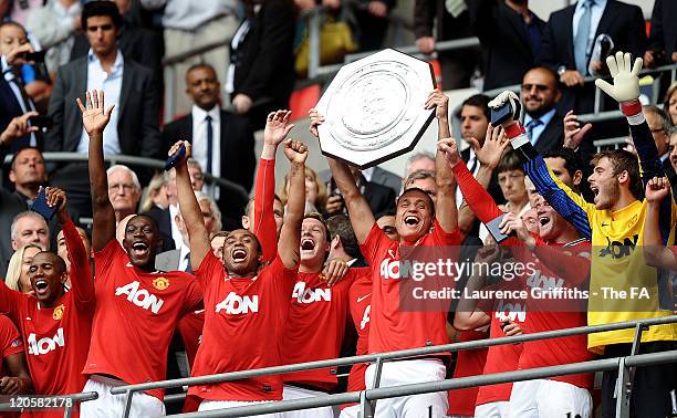 Nemanja Vidic of Manchester United lifts the trophy with team mates after the FA Community Shield match sponsored by McDonald's between Manchester...