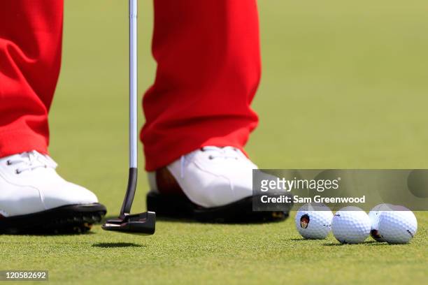 Detailed shot of Ryo Ishikawa's shoes, putter and golf balls are seen as he putts on the practice range prior to starting his final round of the...