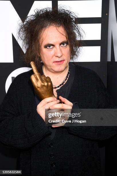 Robert Smith of The Cure poses withthe Awards for Best Festival Headliner during the NME Awards 2020 at O2 Academy Brixton on February 12, 2020 in...