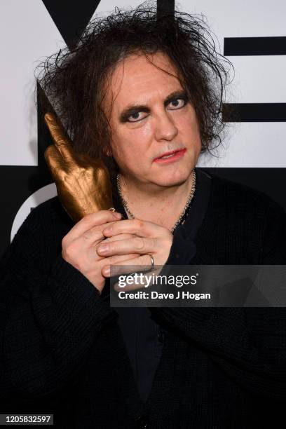 Robert Smith of The Cure poses withthe Awards for Best Festival Headliner during the NME Awards 2020 at O2 Academy Brixton on February 12, 2020 in...