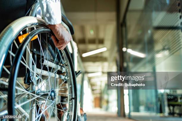 back view of unrecognizable person in a wheelchair in a hallway - capacidades diferentes imagens e fotografias de stock