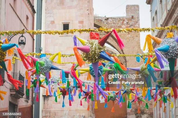 piñatas decorating a street in zacatecas.  mexico. december 2019. christmas decoration. - piñata fotografías e imágenes de stock