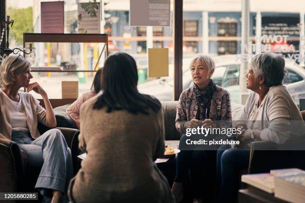 good friends share their favourite books - mature women cafe stock pictures, royalty-free photos & images
