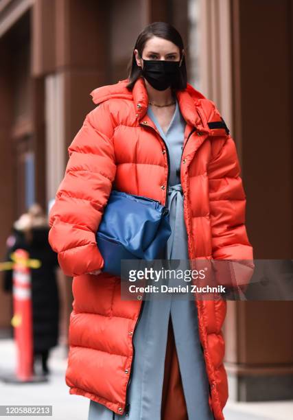 Marina Ingvarsson is seen wearing an orange puffer coat and blue bag outside the Michael Kors show during New York Fashion Week: A/W20 on February...