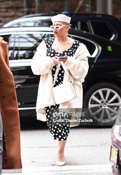 Guest is seen wearing a Michael Kors polkadot dress outside the Michael Kors show during New York Fashion Week: A/W20 on February 12, 2020 in New...