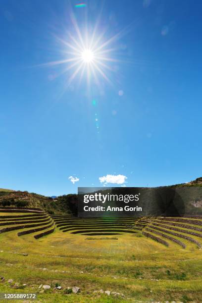 inca terraces of moray on spring afternoon with overhead sunburst, peru - moray inca ruin stock pictures, royalty-free photos & images
