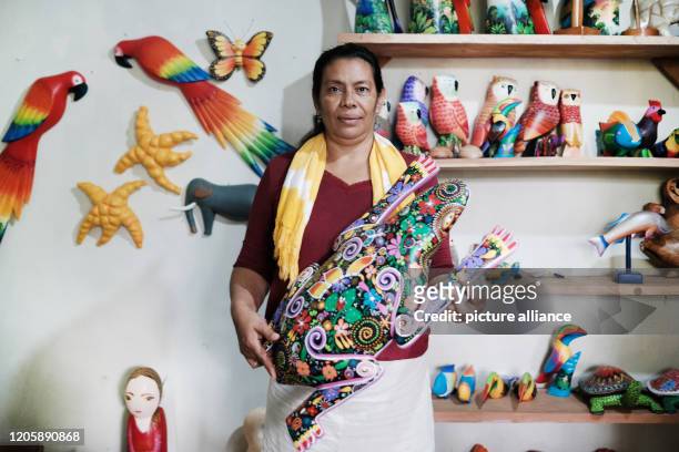 March 2020, Nicaragua, Solentiname: Jamileth Ponce Velásquez shows one of the finished sculptures, which are then sold to tourists and support her...