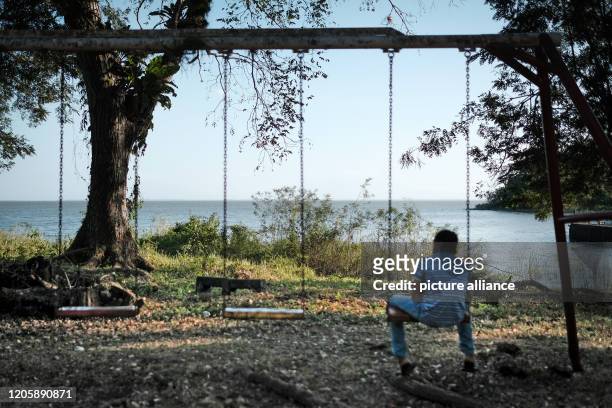 March 2020, Nicaragua, Solentiname: A resident of the island of Mancarrón in the Solentiname archipelago in Nicaragua looks out on a swing at the...