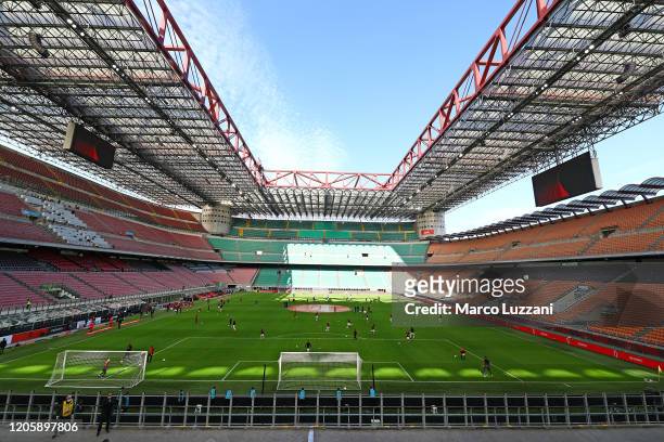 Milan and Genoa CFC players warm up in the empty stadium after rules to limit the spread of Covid-19 have been put in place before the Serie A match...