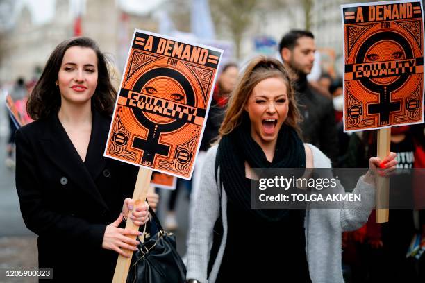 Demonstrators attend the "March4Women" during the International Women's Day in London on March 8, 2020. - Many feminist groups held online campaigns...