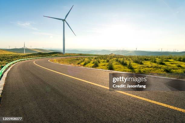 wind turbine - green road imagens e fotografias de stock