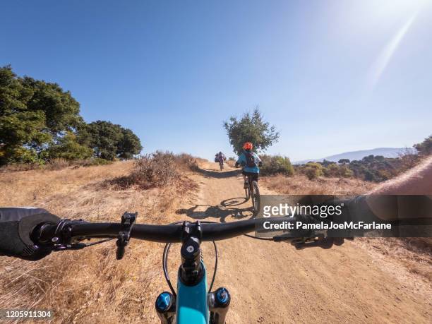 pov, father mountain biking with family on off road trail - daily life in silicon valley stock pictures, royalty-free photos & images