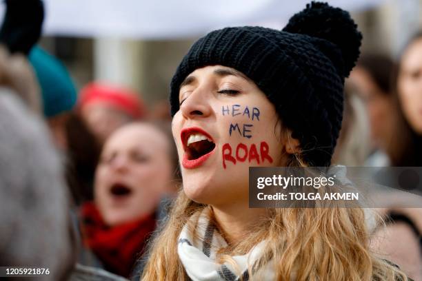 Woman shouts slogans as demonstrators attend the "March4Women" during the International Women's Day in London on March 8, 2020. - Many feminist...