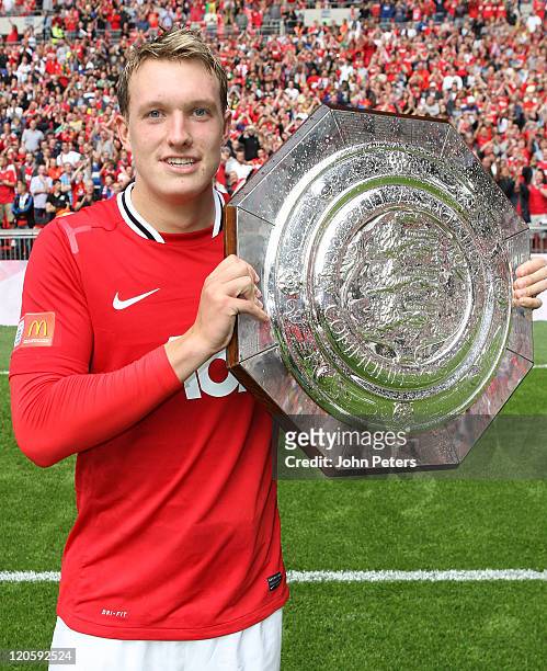 Phil Jones of Manchester United poses with the Community Shield trophy after the FA Community Shield match between Manchester City and Manchester...