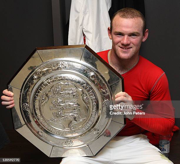 Wayne Roooney of Manchester United pose in the dressing room with the Community Shield trophy after the FA Community Shield match between Manchester...