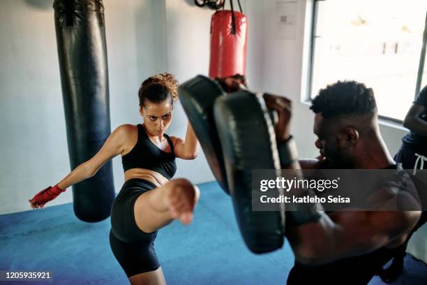 her kicking technique gets better each day - muay thai stock pictures, royalty-free photos & images