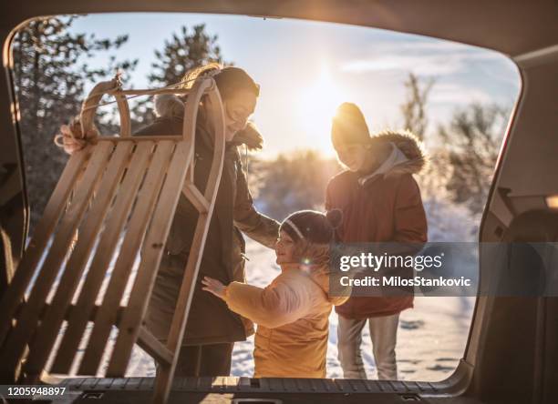 family going to have some fun with sleds on snow - kids playing in snow imagens e fotografias de stock