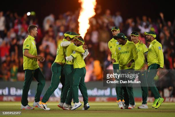 The South Africa players celebrate with Quinton de Kock of South Africa after running out Chris Jordan of England to secure victory by one run during...