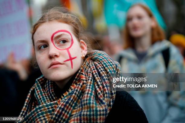 Girl attends the "March4Women" during the International Women's Day in London on March 8, 2020. - Many feminist groups held online campaigns instead...