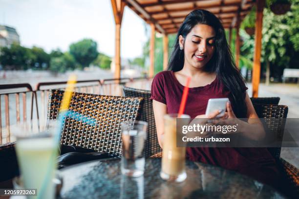 beautiful gypsy young woman in cafe - roma capucino stock pictures, royalty-free photos & images