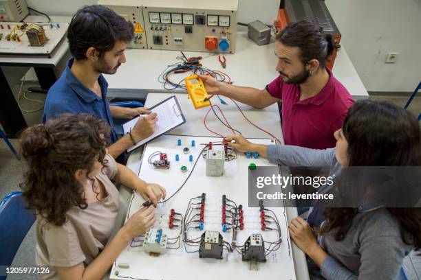 small group of students in electrical engineering laboratory - engeneer student electronics stock pictures, royalty-free photos & images