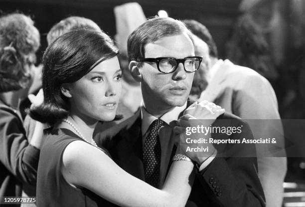 French actor Jean-Louis Trintignant and Grazia Maria Spina hugging each other while dancing in the film The Success. 1963
