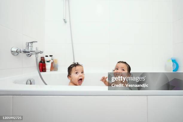 babys lieben es zu baden - brothers bathroom stock-fotos und bilder