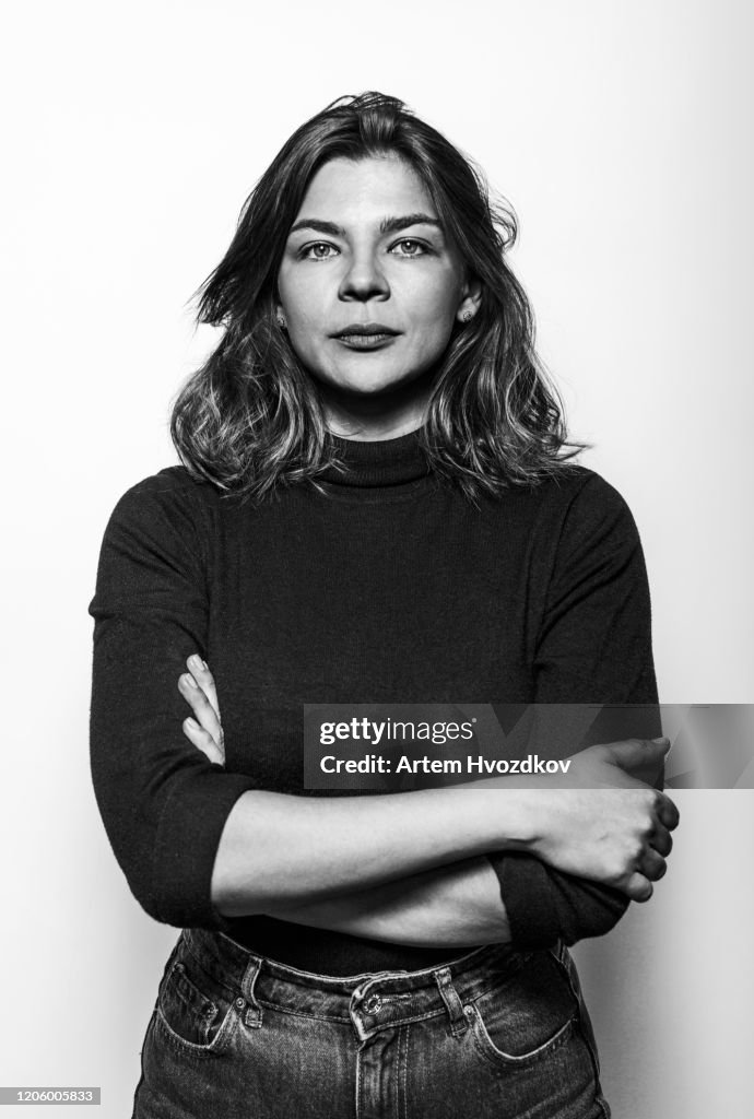 Adult young seriously looking in camera against white background