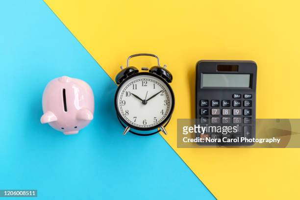 piggy bank, alarm clock and calculator - schuldenberatung stock-fotos und bilder