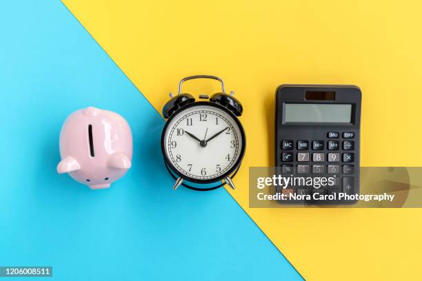 piggy bank, alarm clock and calculator - the debt clock stock pictures, royalty-free photos & images