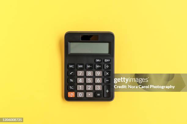 calculator on yellow background - calculator top view stock-fotos und bilder