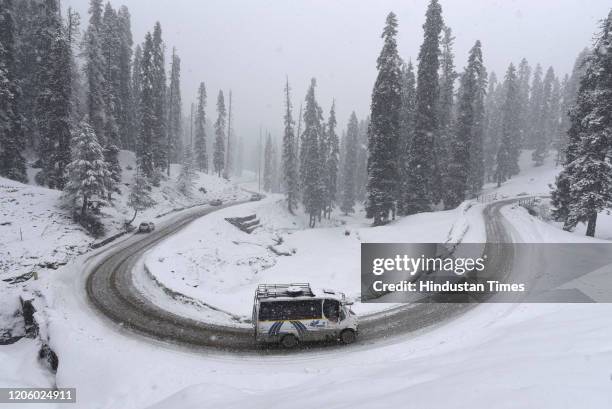 Vehicle seen passing through snow covered Gulmarg road during fresh snowfall, about 55Kms from Srinagar, on March 7, 2020 in Srinagar, India.