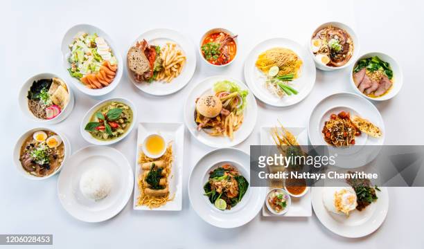 high angle view of variety food on table - stock photo - chicken satay stock-fotos und bilder