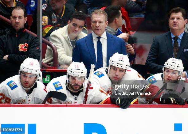 Head coach Geoff Ward of the Calgary Flames looks on from the bench during their NHL game against the Vancouver Canucks at Rogers Arena February 8,...