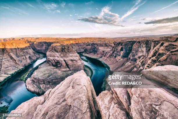 Dawn at Horseshoe Bend. Sunrise colors with Rocks and Colorado River..